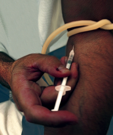 A Detroit man injects an advance sample of Zom-B. CIA officials expect the new drug to be even more popular than crack.